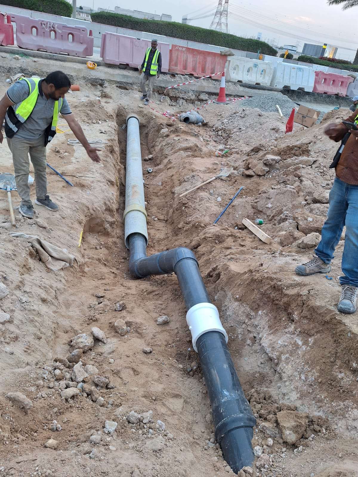 Irrigation pipes being installed in a trench